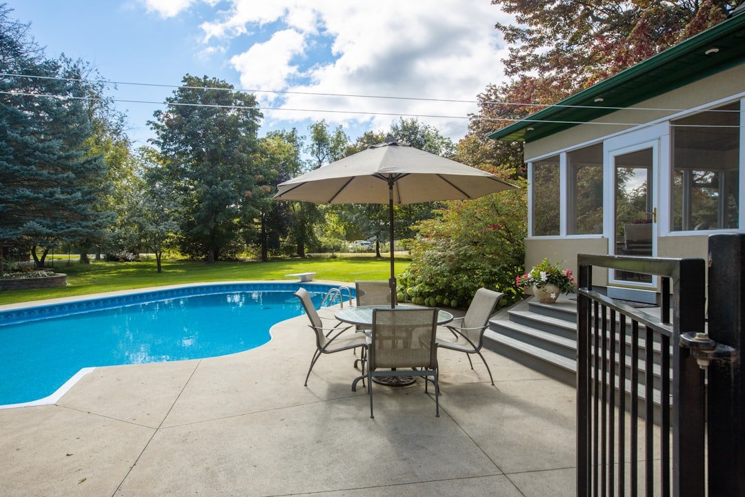 A backyard swimming pool with safety fencing