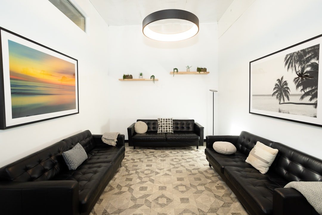 Bright, tidy therapy lounge with sofas and framed nature prints