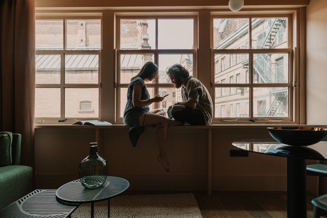 Two people in conversation on a sofa