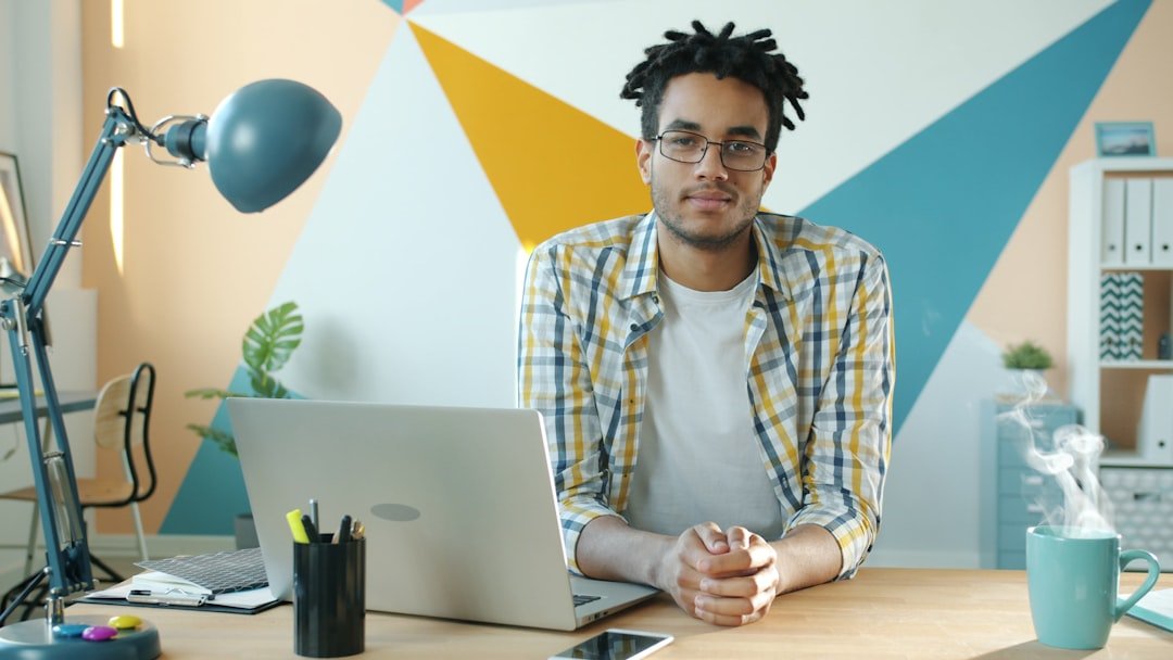 A small business owner working on a laptop