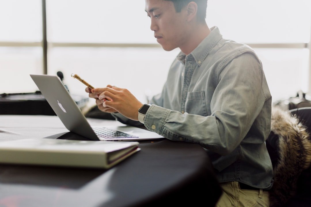 A business owner reviewing documents on a laptop
